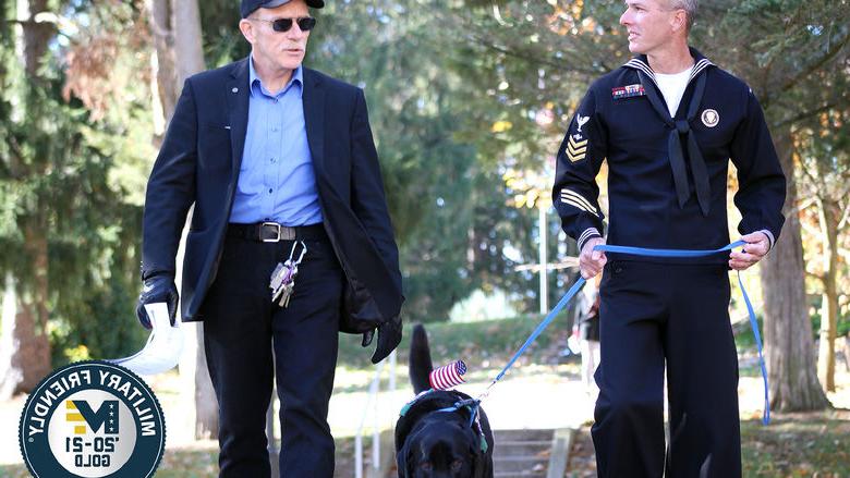 Student veteran John Wiesniewski and his service dog, Slate, cross campus with a veteran faculty member at Penn State Mont Alto.